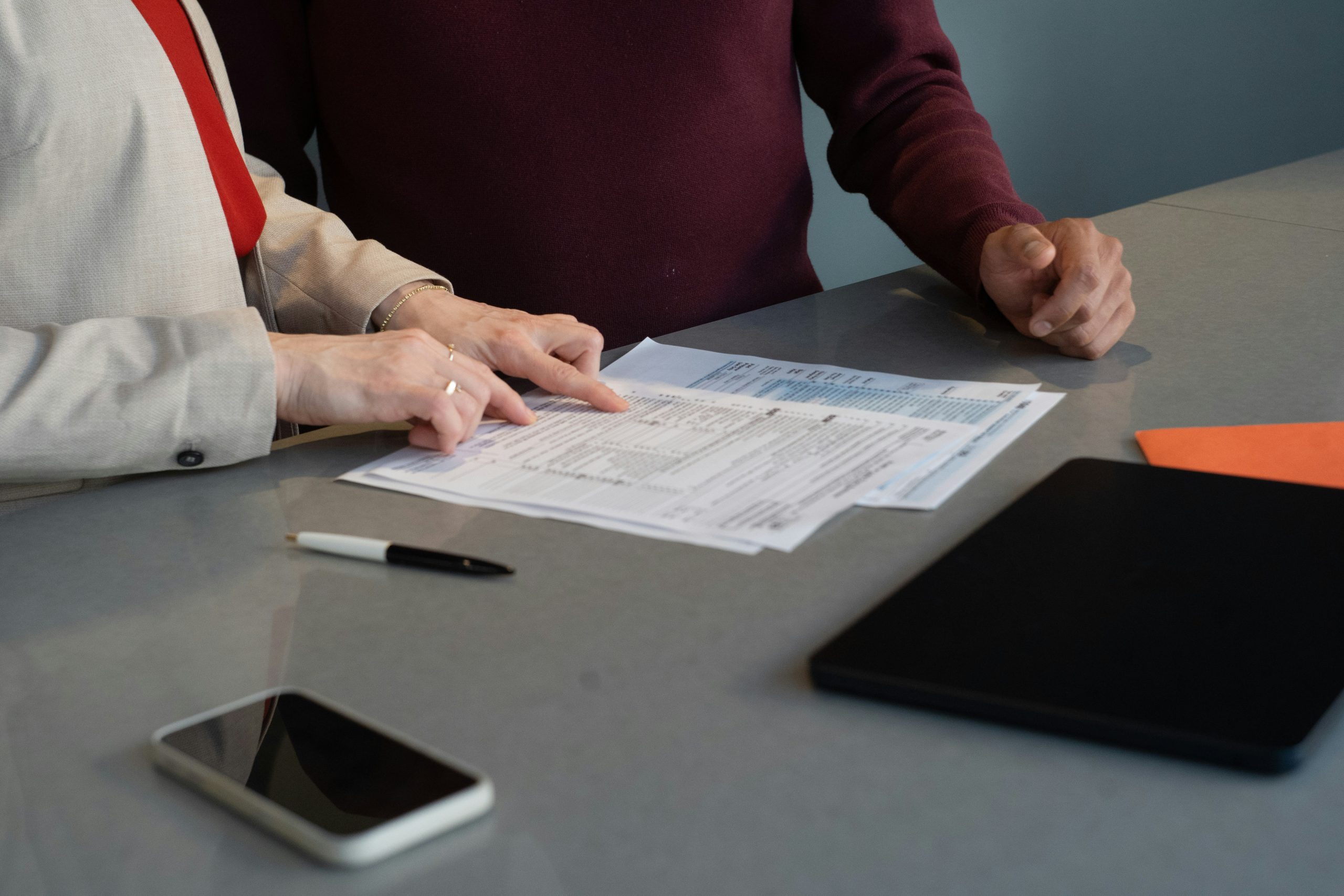 Professionals reviewing financial documents at a conference table