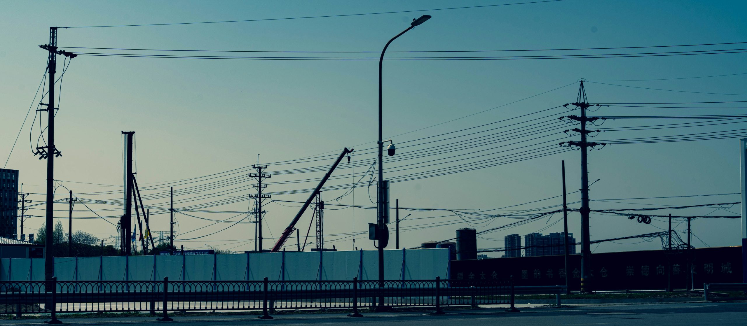 Industrial infrastructure and construction assets at dusk