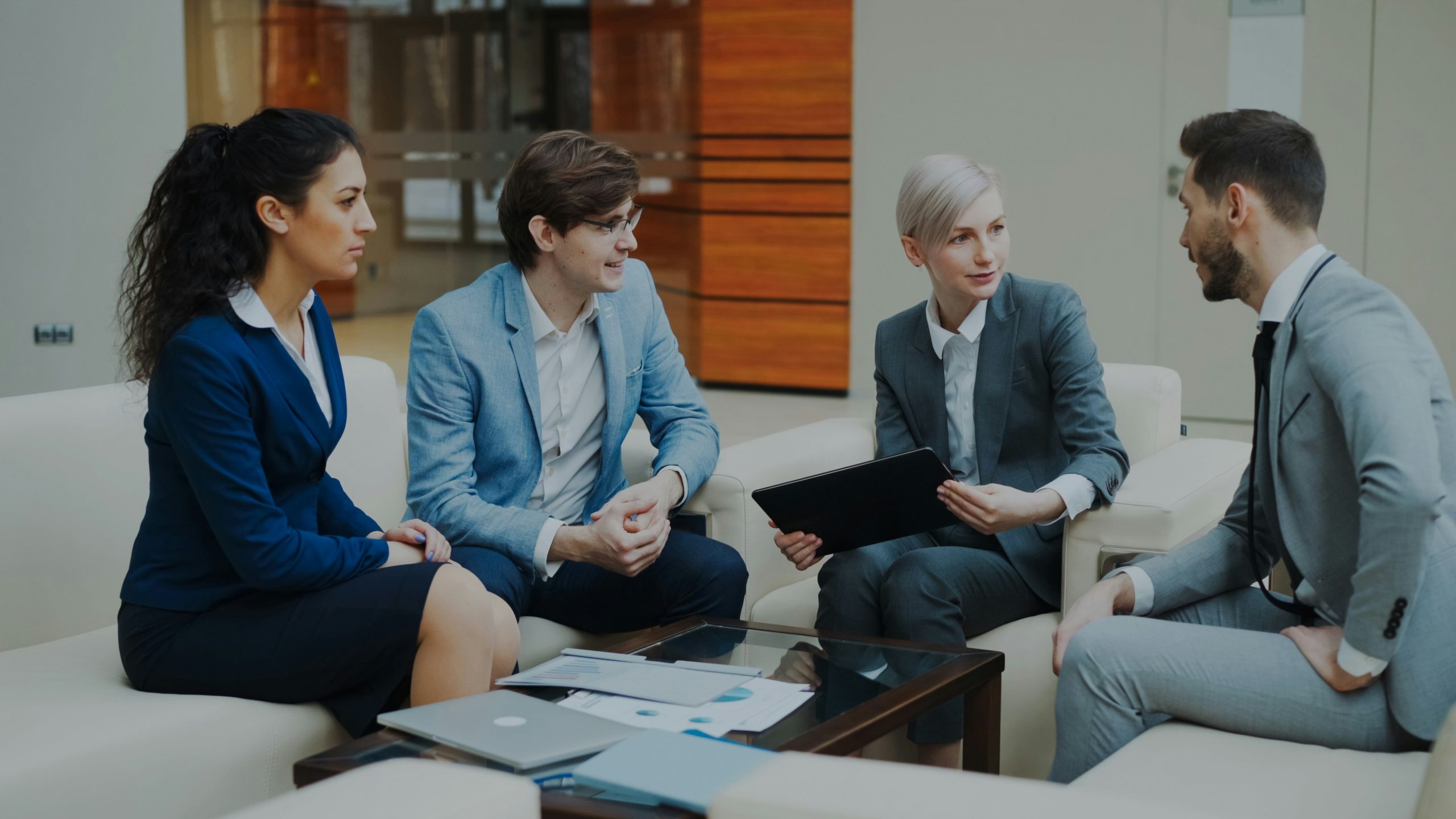 Financial advisory team discussing documents in a modern office